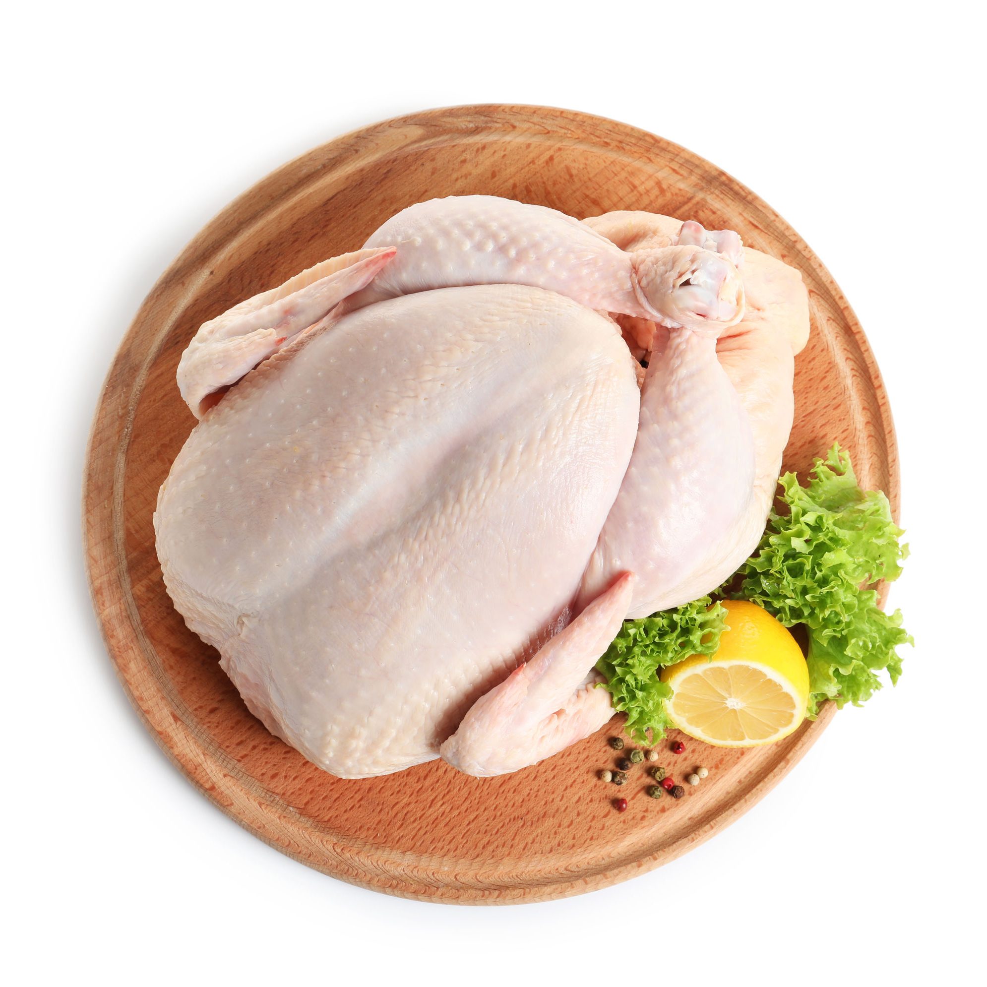 Wooden board with raw turkey and ingredients on white background, top view